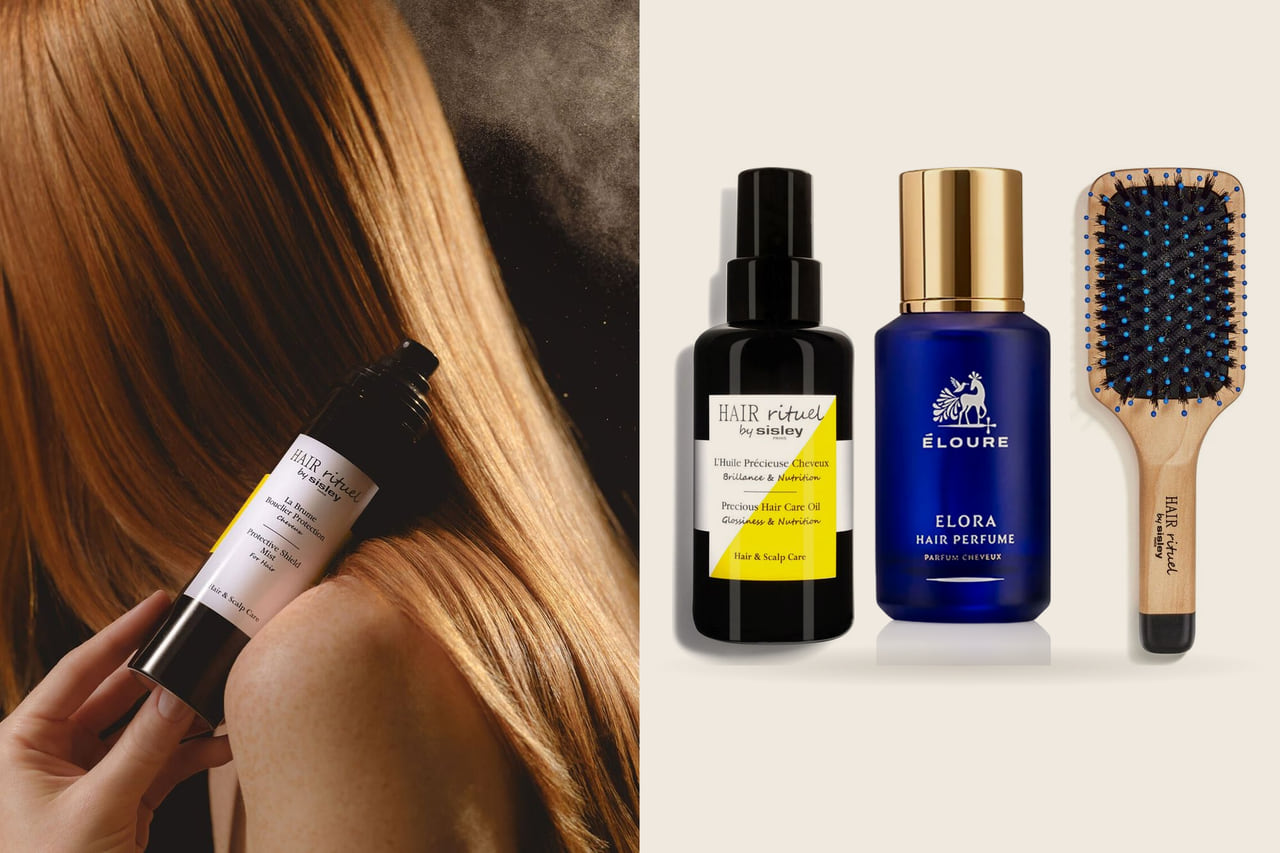 Left, a hand holds a Sisley hair oil against long glossy copper hair; right, a Sisley hair oil, a Maison Éloure hair perfume and a Sisley pocket brush on a warm stone ground.